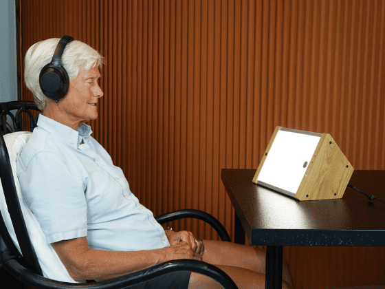 Older woman using EVY LIGHT while listening to music