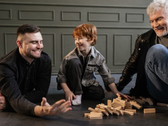 Grandfather, son and grandchild playing together and laughing