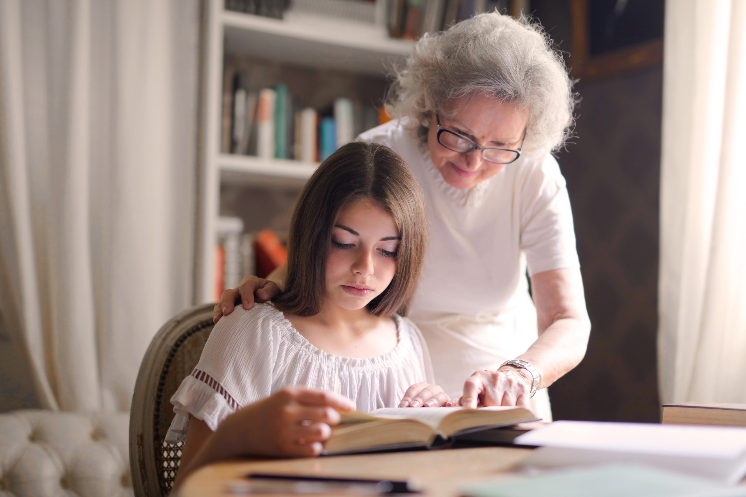 grandma and a girl reading a book