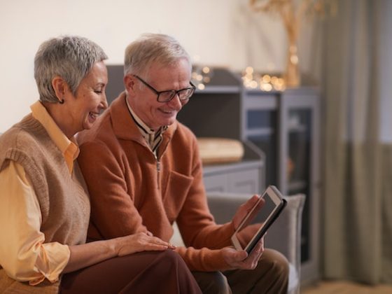 Older couple looking into a tablet
