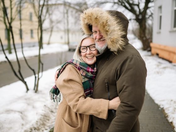 older couple happy and hugging outside in winter