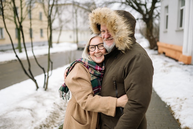older couple happy and hugging outside in winter