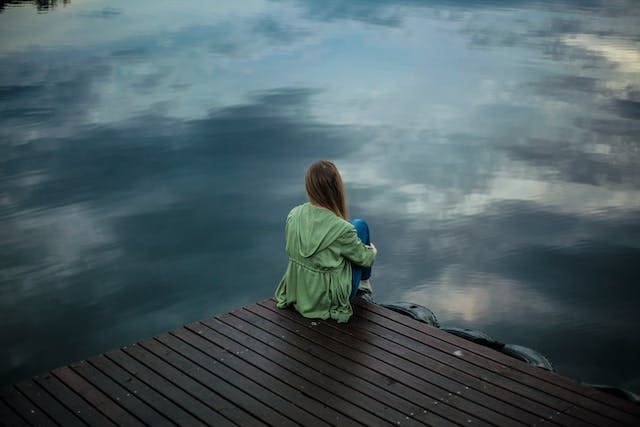 woman-sitting-alone-by-a-lake-for-green-light-therapy-for-depression